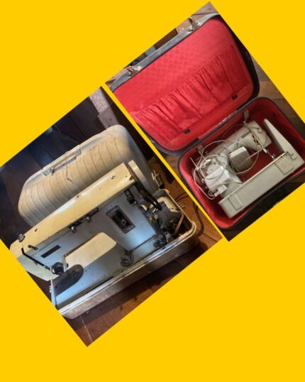 Máquina de coser antigua con maleta